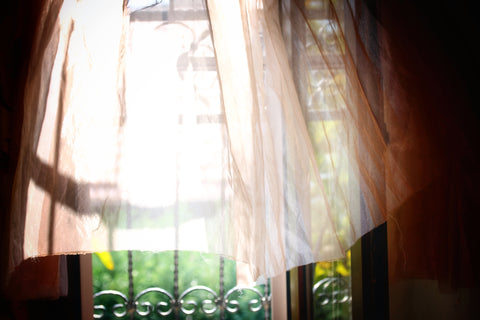 Opened Window and a Curtain Blown by the Air