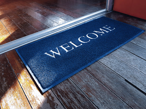 Blue Welcome Doormat in Frontdoor