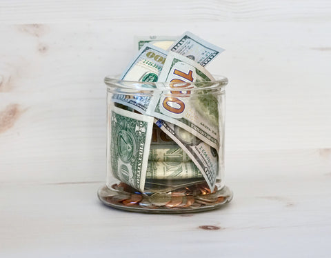 Glass Jar Full of Cash Money and Coins