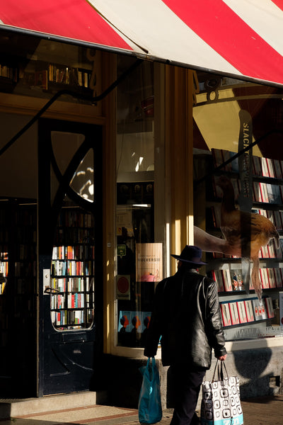An Individual Walking Outside a Bookstore
