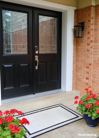 Impressive Home Entrance with Black Door and Flowers