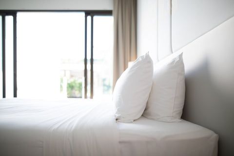 View of a Bedroom Room Across a Big Double Bed
